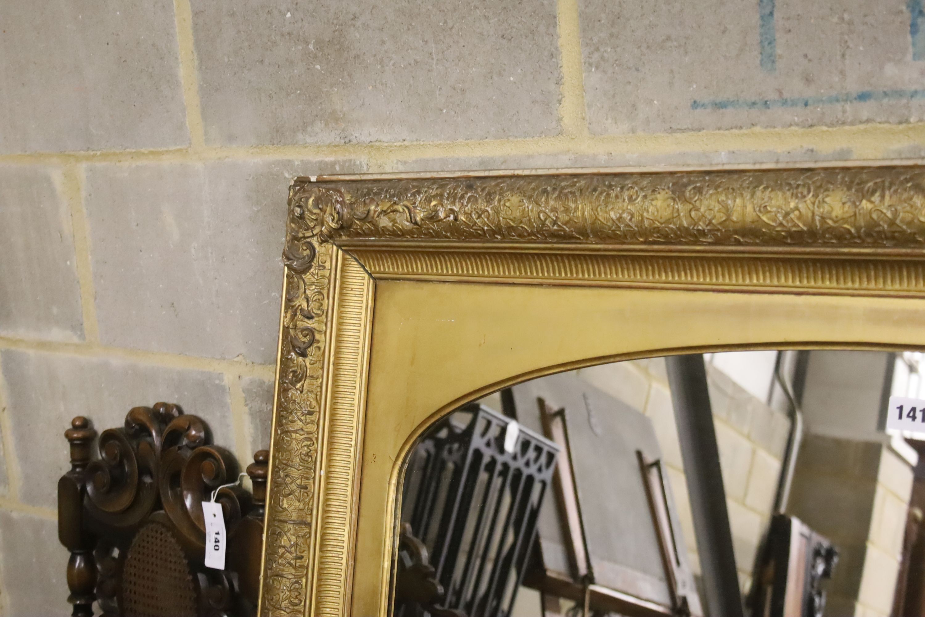 A giltwood and gesso overmantel mirror with arched plate, width 115cm, height 112cm